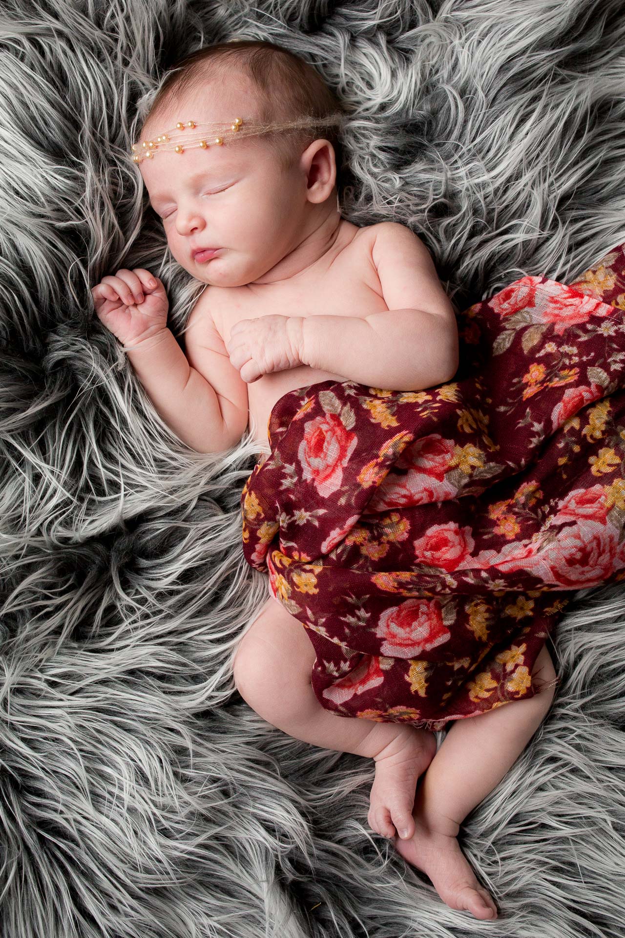 newborn lifestyle baby portrait sleeping on fur blanket