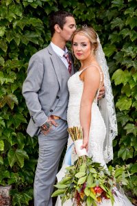 wedding couple in front of ivy outside intimate